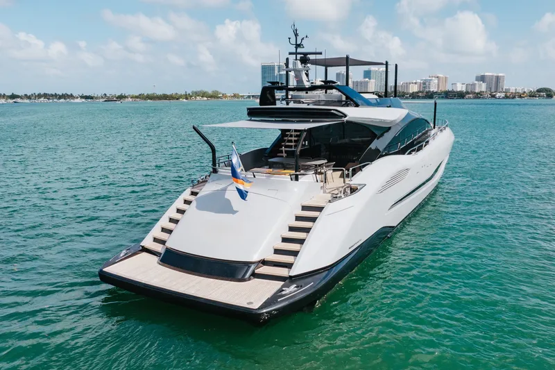 Slide: The Image of 2024 Mangusta 104 REV luxury yacht on serene blue waters. - 10