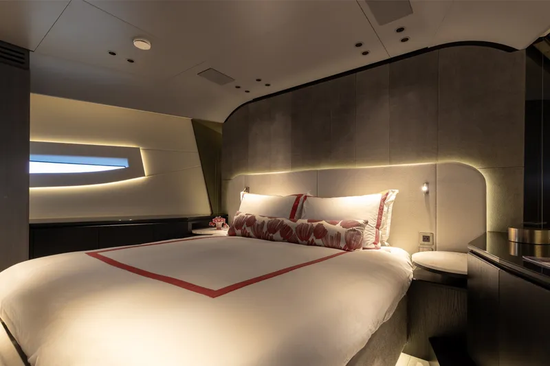 Slide: The Image of Luxurious bedroom interior of 2024 Mangusta 104 REV yacht, featuring elegant lighting and modern design. - 37