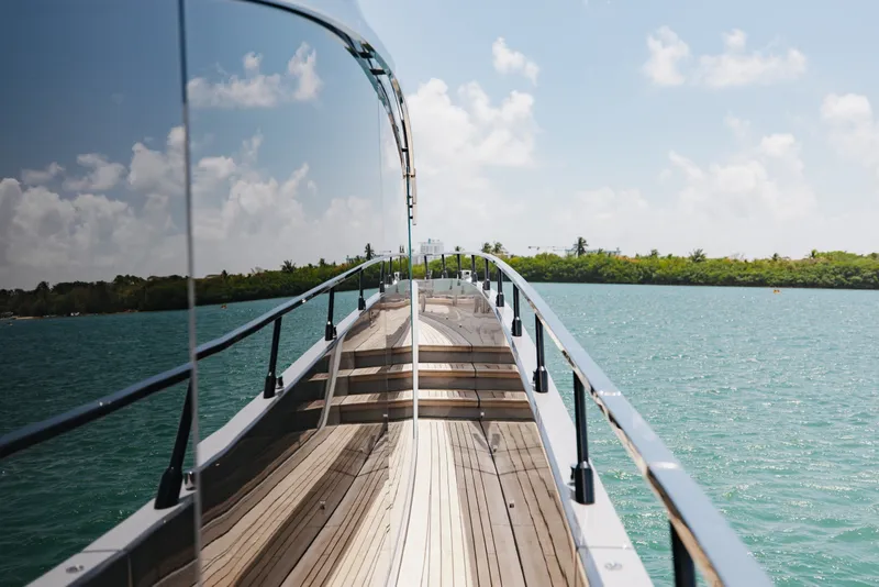 Slide: The Image of 2024 Mangusta 104 REV yacht deck with ocean view and clear skies. - 52