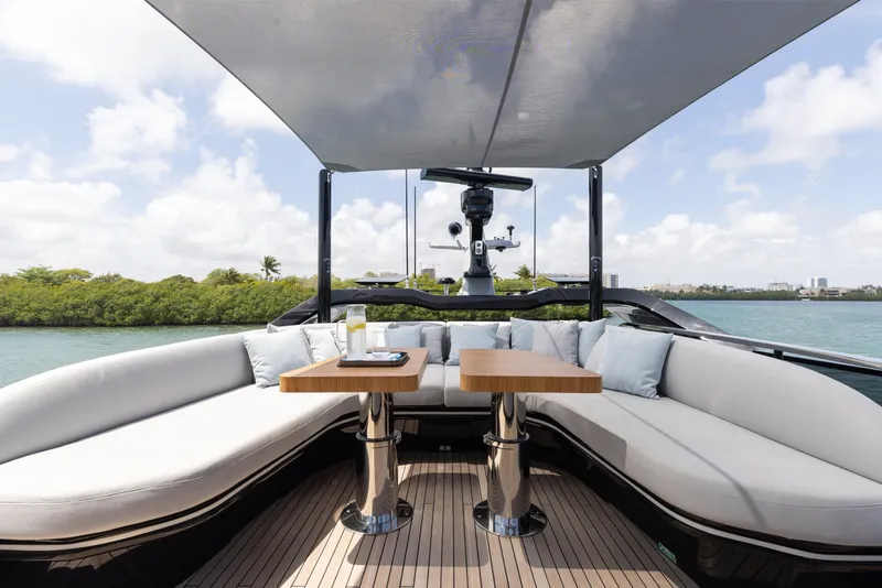 Slide: The Image of Luxurious 2024 Mangusta 104 REV yacht deck with elegant seating and scenic water view. - 54
