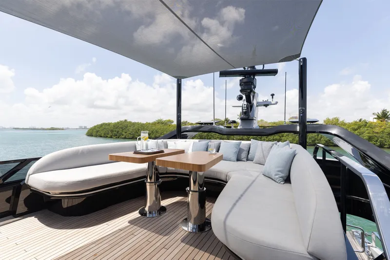 Slide: The Image of Luxurious 2024 Mangusta 104 REV yacht deck with elegant seating and scenic water views. - 55