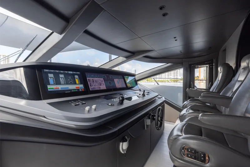 Slide: The Image of 2024 Mangusta 104 REV yacht cockpit with advanced navigation controls and luxurious seating. - 51