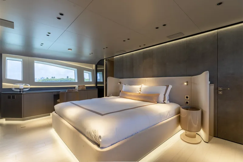Slide: The Image of Luxurious bedroom interior on 2024 Mangusta 104 REV yacht, featuring modern design and ambient lighting. - 26