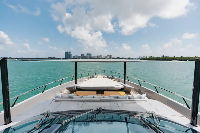 Slide: The Image of 2024 Mangusta 104 REV yacht cruising on turquoise waters under a clear sky. - 67