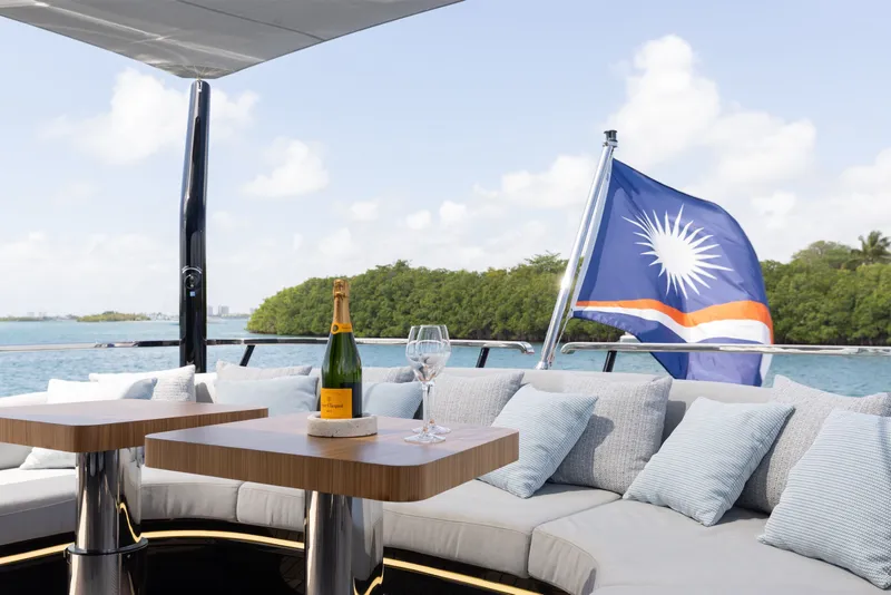 Slide: The Image of Luxurious 2024 Mangusta 104 REV yacht deck with champagne and ocean view. - 56
