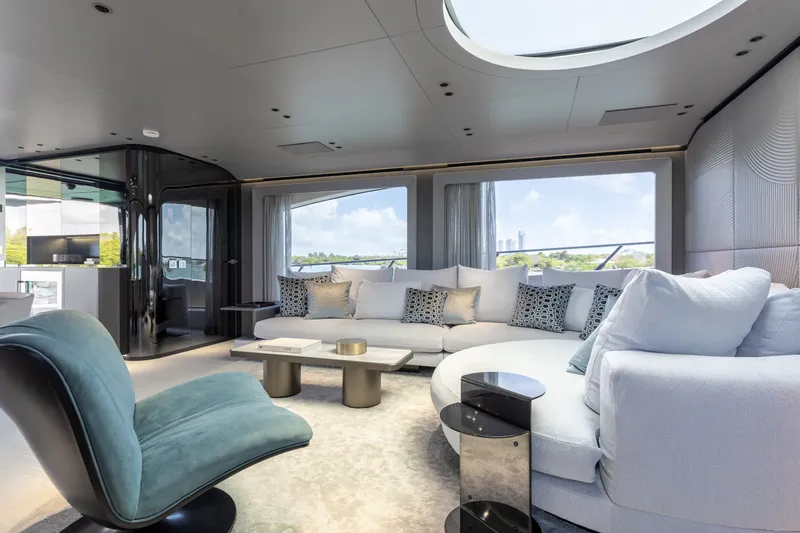 Slide: The Image of Luxurious interior of 2024 Mangusta 104 REV yacht with modern seating and panoramic windows. - 24