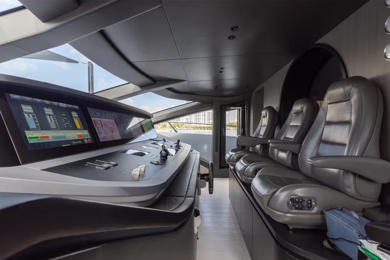 Slide: The Image of Luxurious 2024 Mangusta 104 REV yacht cockpit with advanced navigation controls and plush seating. - 3