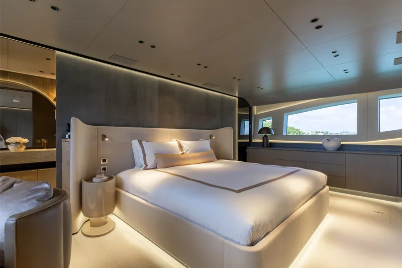Slide: The Image of Luxurious bedroom interior of 2024 Mangusta 104 REV yacht, featuring modern design and ambient lighting. - 4