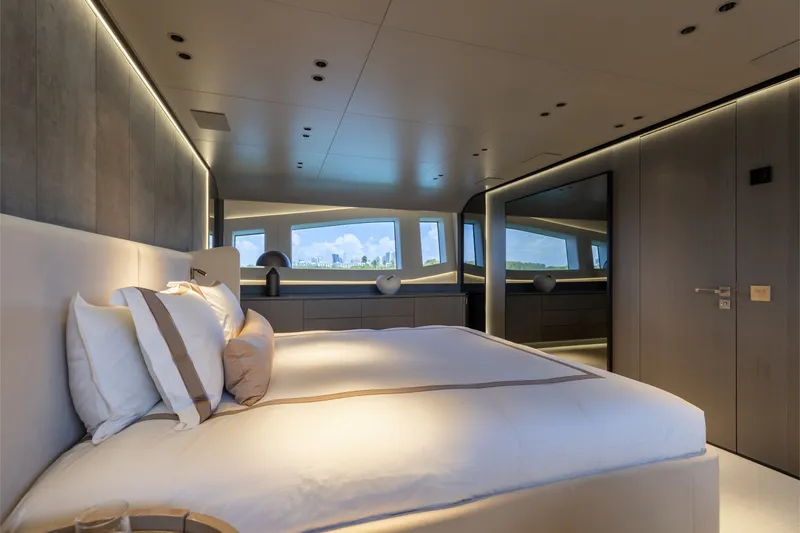 Slide: The Image of Luxurious bedroom interior of 2024 Mangusta 104 REV yacht with modern design and large windows. - 27
