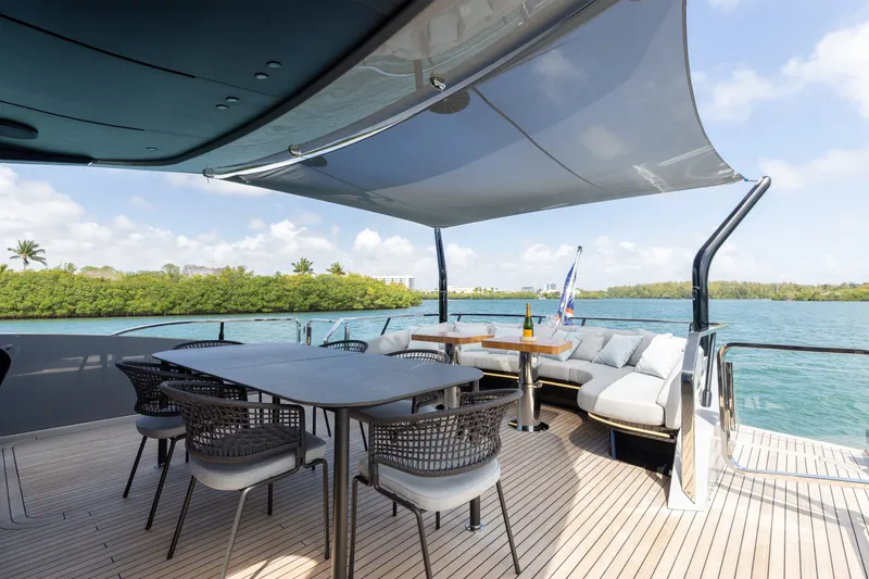 Slide: The Image of Luxurious deck of 2024 Mangusta 104 REV yacht with elegant seating and scenic water view. - 16