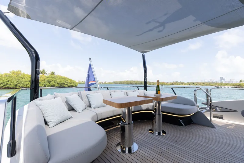 Slide: The Image of Luxurious 2024 Mangusta 104 REV yacht deck with elegant seating and scenic water views. - 58