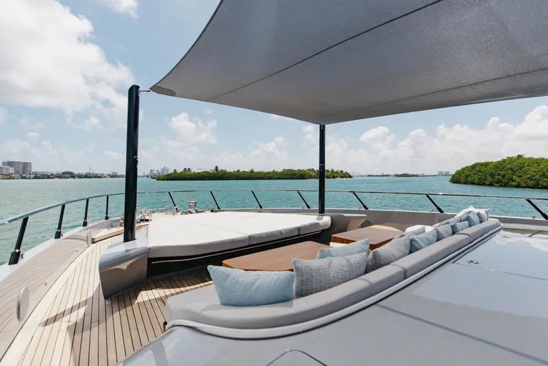 Slide: The Image of Luxurious deck of 2024 Mangusta 104 REV yacht with ocean view and comfortable seating. - 63