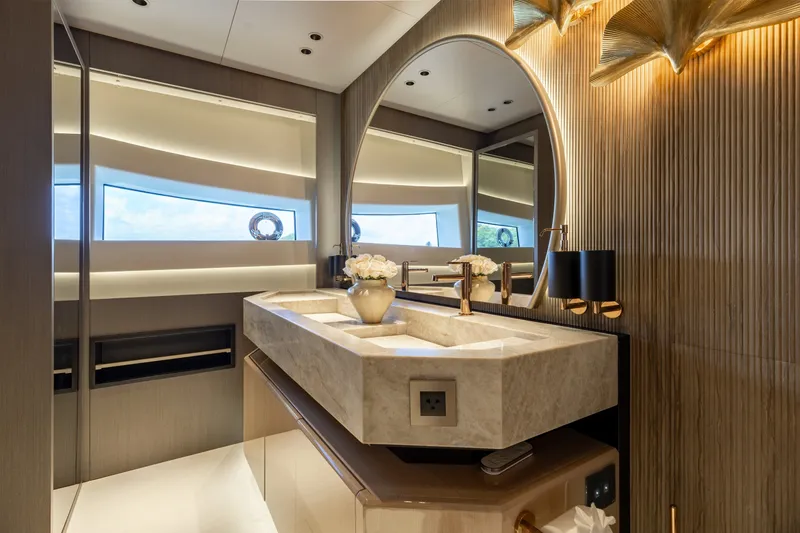 Slide: The Image of Luxurious bathroom interior of 2024 Mangusta 104 REV yacht with elegant marble sink and modern lighting. - 33