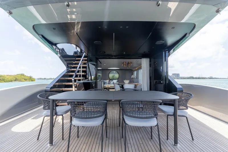 Slide: The Image of Luxurious 2024 Mangusta 104 REV yacht deck with elegant dining area and modern design. - 15
