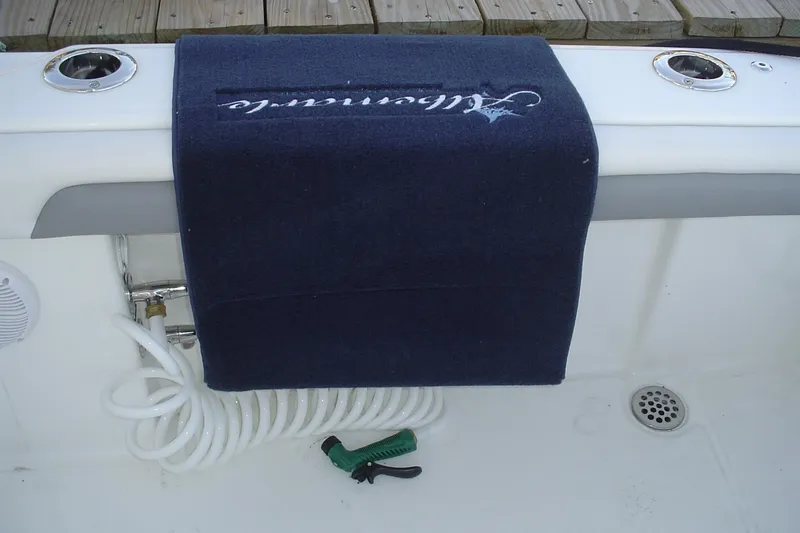 Slide: The Image of 2024 Albemarle 27 Dual Console boat deck with coiled hose and towel. - 17