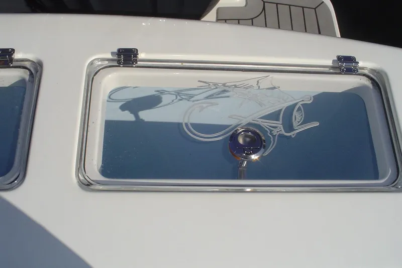 Slide: The Image of 2024 Albemarle 27 Dual Console boat window with etched fish design. - 44