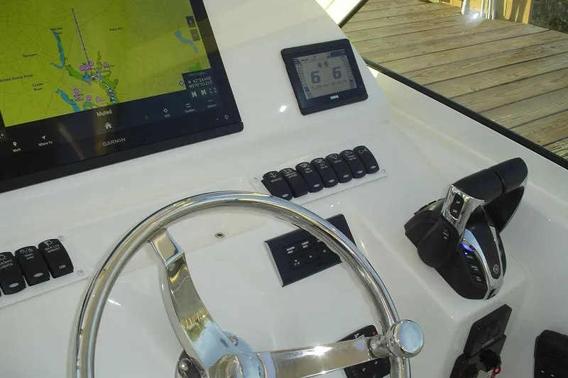 Slide: The Image of 2024 Albemarle 27 Dual Console helm with Garmin navigation and Yamaha controls. - 27