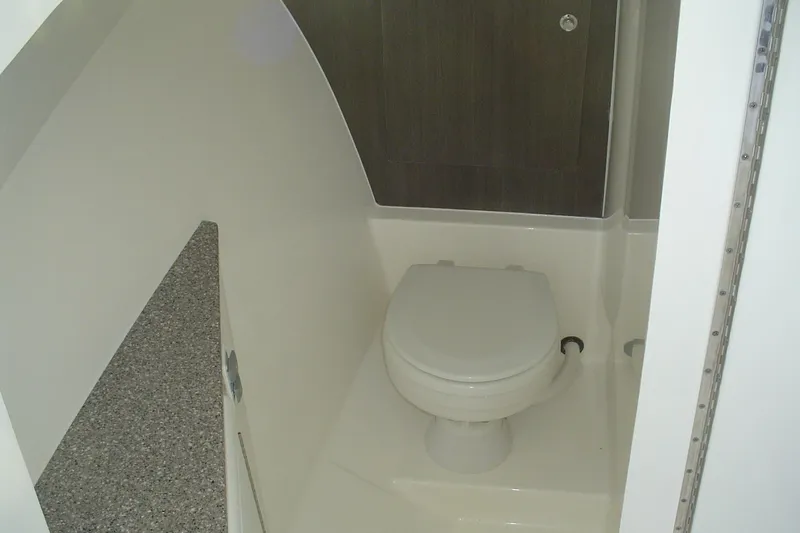 Slide: The Image of 2024 Albemarle 27 Dual Console boat interior bathroom with toilet and countertop. - 30