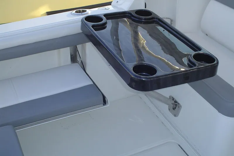 Slide: The Image of 2024 Albemarle 27 Dual Console boat interior with cup holder tray. - 38
