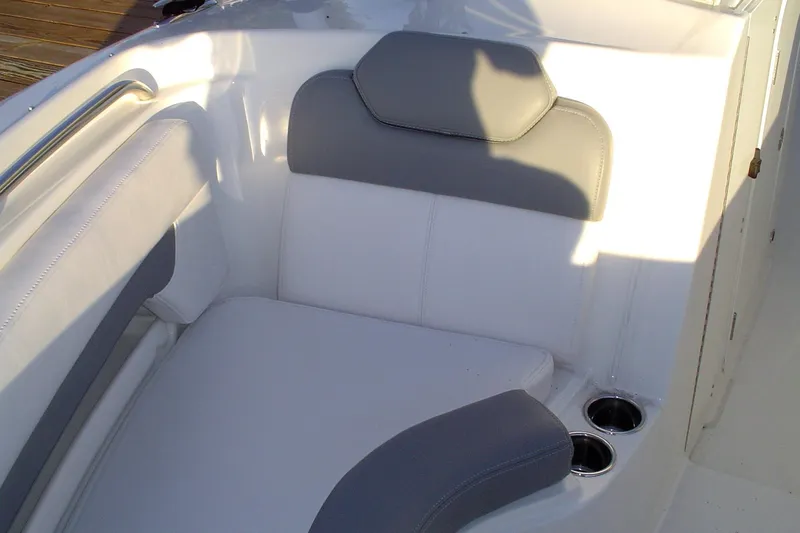 Slide: The Image of 2024 Albemarle 27 Dual Console boat seating with cup holders, featuring gray and white upholstery. - 35