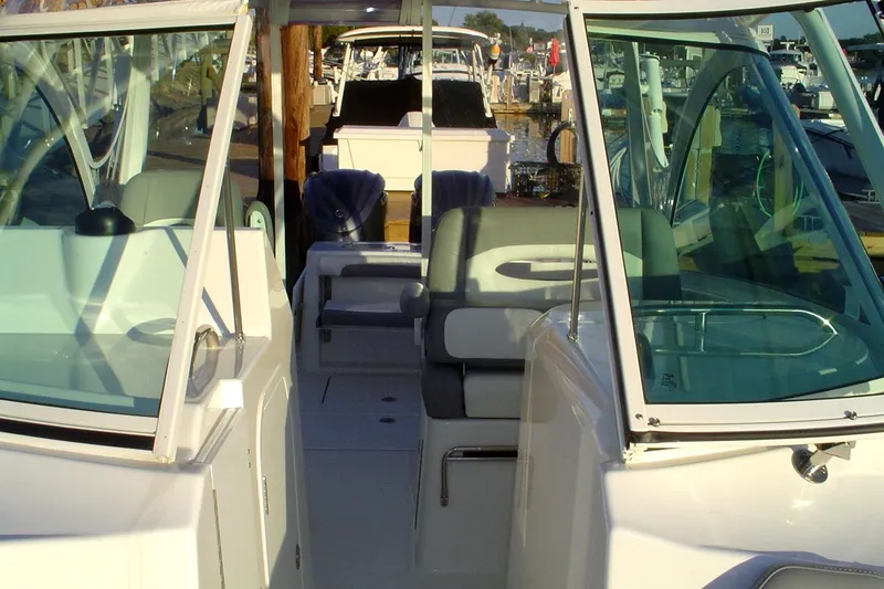 Slide: The Image of 2024 Albemarle 27 Dual Console boat interior with seating and windshield. - 22