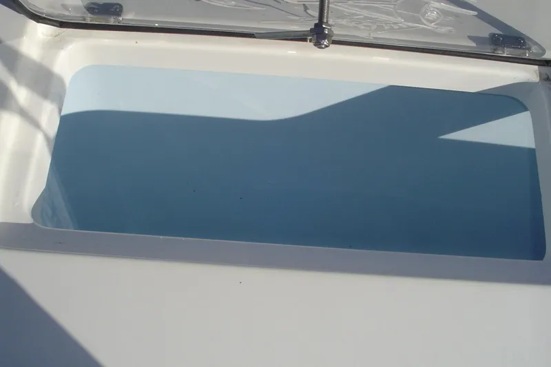 Slide: The Image of 2024 Albemarle 27 Dual Console boat storage compartment with open lid. - 43