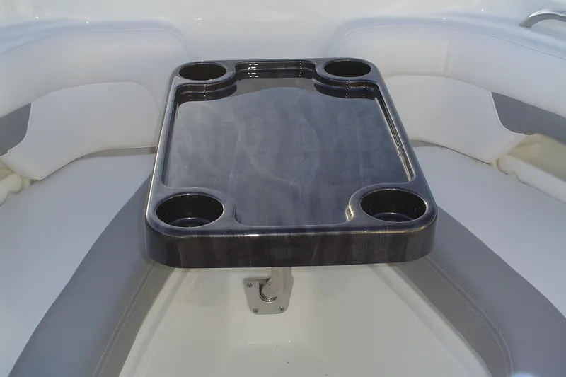 Slide: The Image of 2024 Albemarle 27 Dual Console boat interior with table and cup holders. - 34