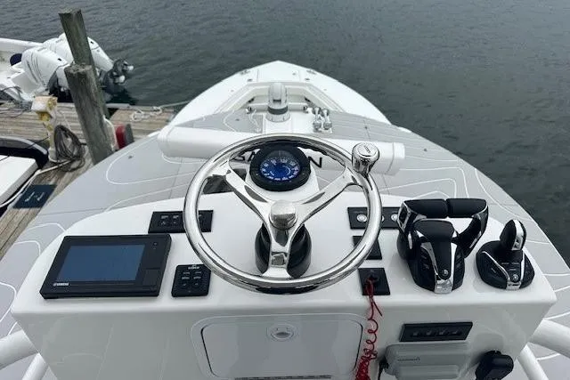 Slide: The Image of 2022 Regulator 41 boat helm with steering wheel, controls, and navigation display. - 31