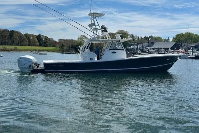 The Image of 2022 Regulator 41 boat on calm water with scenic background. - 1