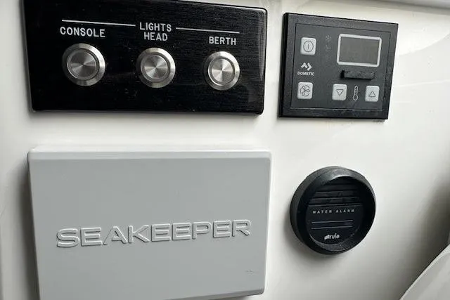 Slide: The Image of Control panel of a 2022 Regulator 41 boat featuring Seakeeper and water alarm. - 24