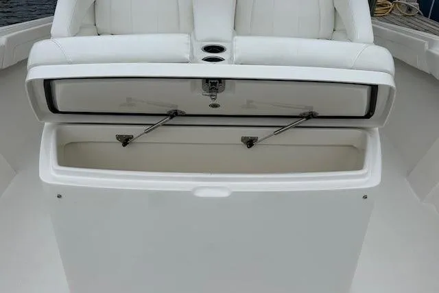 Slide: The Image of Open storage compartment on 2022 Regulator 41 boat with white seating. - 25