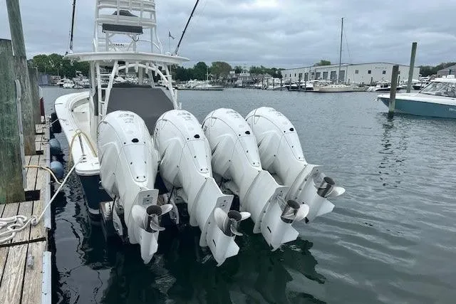 Slide: The Image of 2022 Regulator 41 boat with four powerful outboard engines docked at marina. - 14