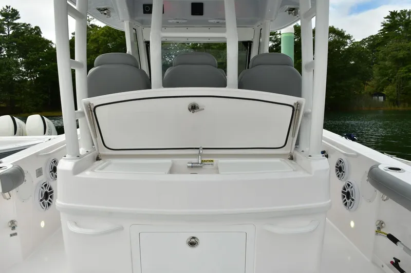 Slide: The Image of 2022 Everglades 335 Center Console boat interior with seating and storage compartments. - 13