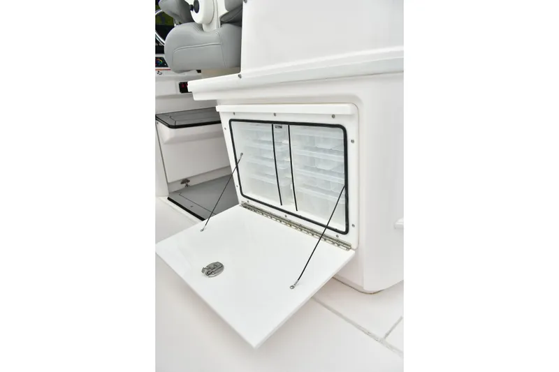Slide: The Image of Storage compartment on 2022 Everglades 335 Center Console boat, featuring organized tackle boxes. - 24