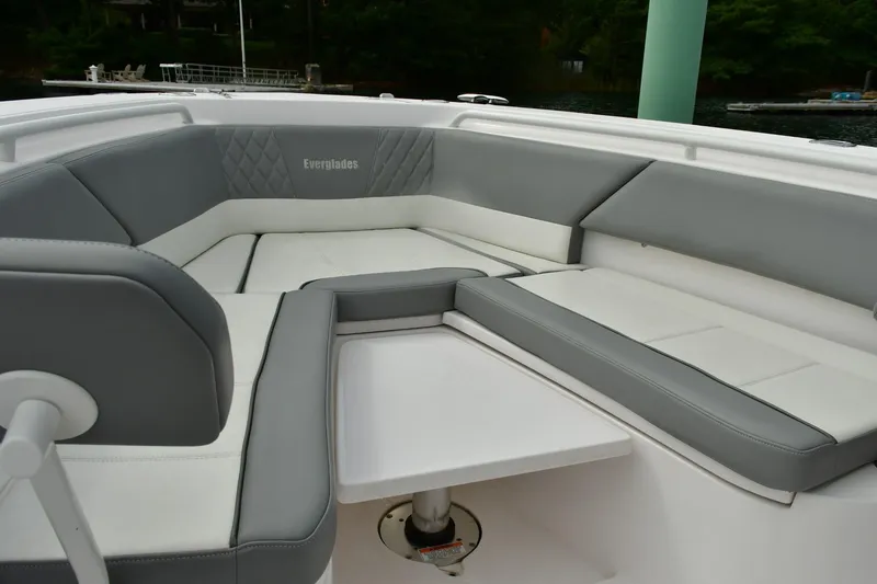 Slide: The Image of 2022 Everglades 335 Center Console boat interior with gray and white seating. - 36