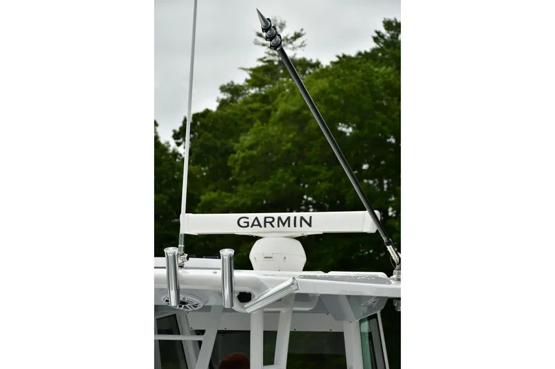 Slide: The Image of 2022 Everglades 335 Center Console with Garmin equipment, surrounded by lush greenery. - 34
