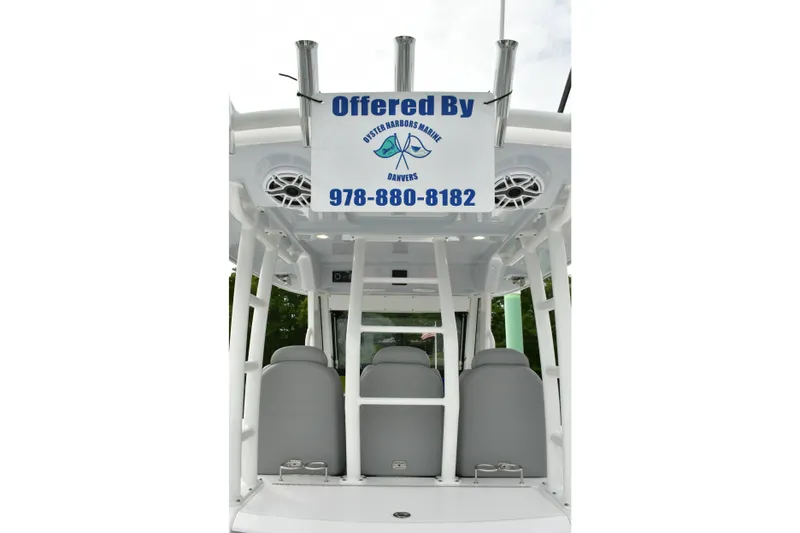 Slide: The Image of 2022 Everglades 335 Center Console boat interior with seating and contact sign. - 19