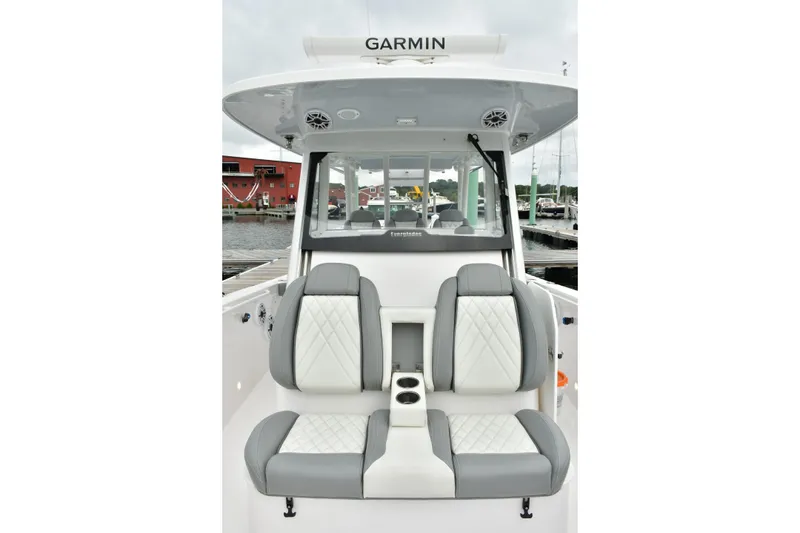 Slide: The Image of 2022 Everglades 335 Center Console boat interior with dual seats and cup holders. - 32