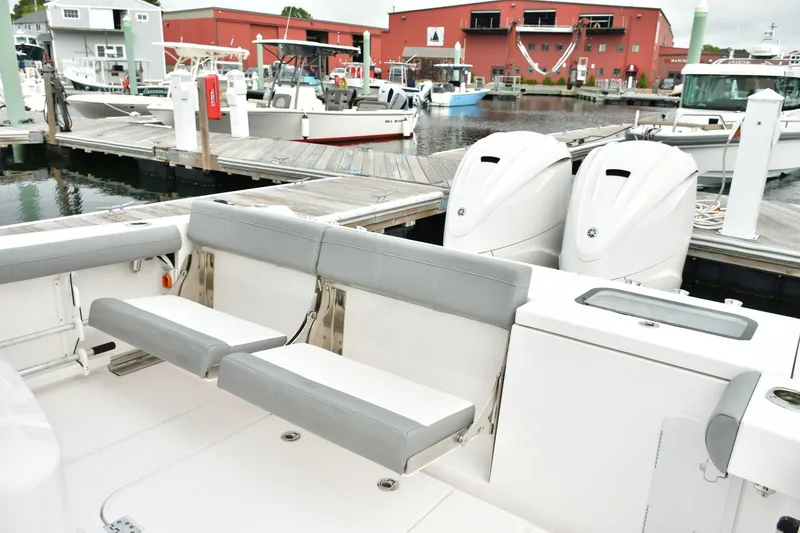 Slide: The Image of 2022 Everglades 335 Center Console boat with dual engines at a marina dock. - 16