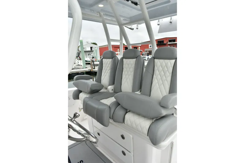 Slide: The Image of Luxurious seating on 2022 Everglades 335 Center Console boat, featuring gray and white upholstery. - 25