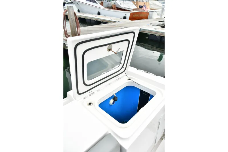 Slide: The Image of Open hatch on 2022 Everglades 335 Center Console boat at marina. - 20