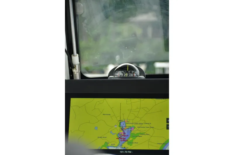 Slide: The Image of Compass and navigation screen on 2022 Everglades 335 Center Console boat. - 8