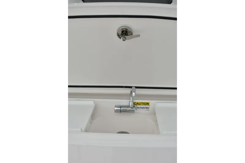 Slide: The Image of 2022 Everglades 335 Center Console sink with caution sign for non-potable water. - 14