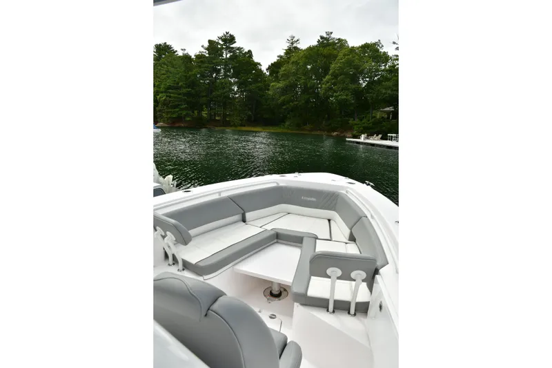 Slide: The Image of 2022 Everglades 335 Center Console boat with spacious seating on a serene lake. - 30