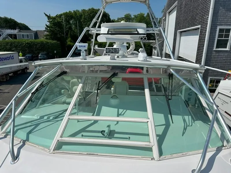Slide: The Image of 2004 Cabo Express boat with windshield and radar equipment, docked near buildings. - 21