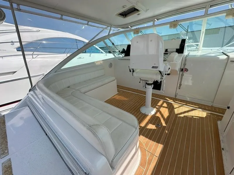 Slide: The Image of 2004 Cabo Express boat interior with white seating and wooden flooring. - 27