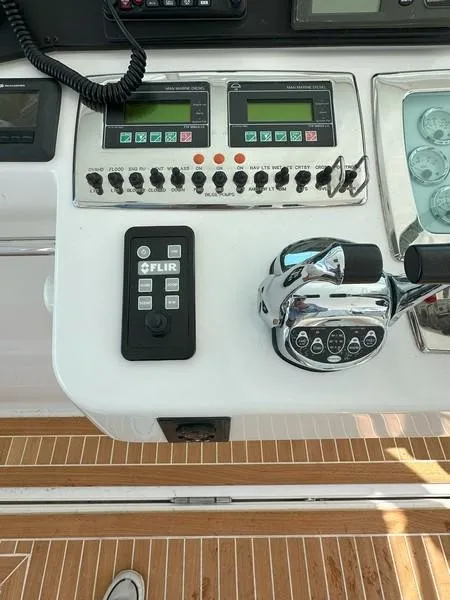 Slide: The Image of Control panel of a 2004 Cabo Express boat with FLIR system and throttle controls. - 33