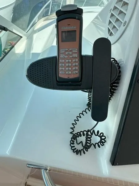 Slide: The Image of Satellite phone mounted on a 2004 Cabo Express boat dashboard. - 32