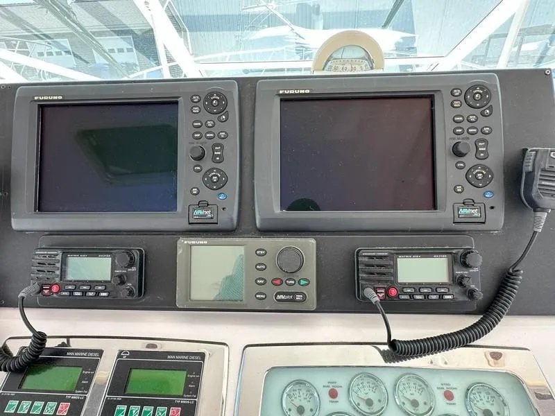 Slide: The Image of Boat dashboard with Furuno navigation systems and communication devices, Cabo Express 2004 model. - 30