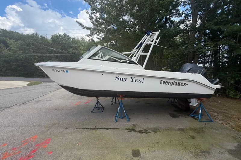 Slide: The Image of 2012 Everglades 230 Dual Console boat on stands, labeled "Say Yes!" - 2